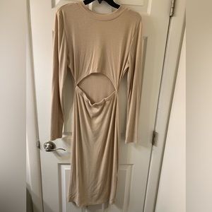 Woman’s long sleeve tan dress with slit in the back